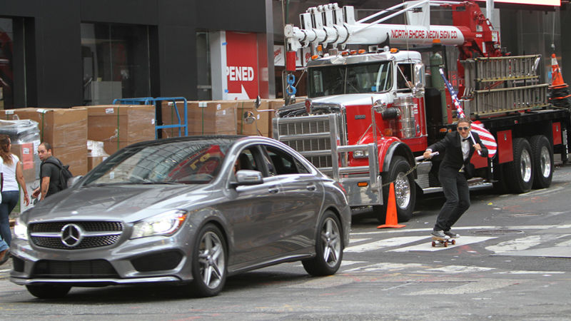 Casey Neistat skateboarding behind Merceds CLA